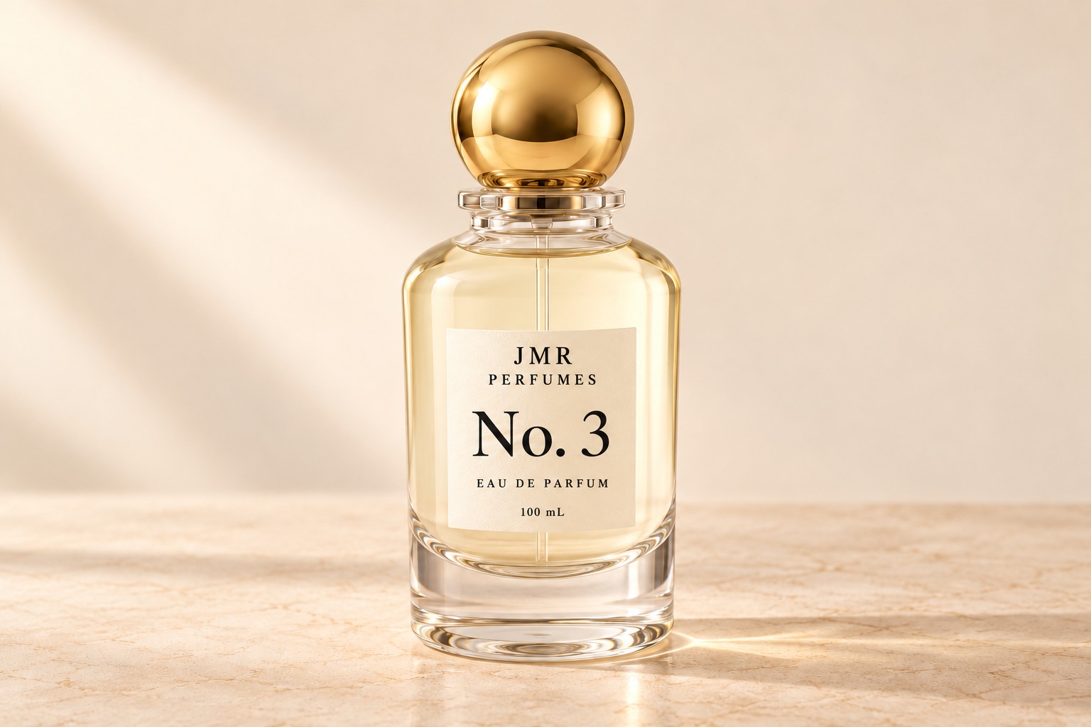 Studio visualization of the JMR No. 3 bottle, with cream label and spherical gold cap